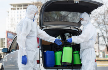 people in protective suits planning to do disinfection with chemicals