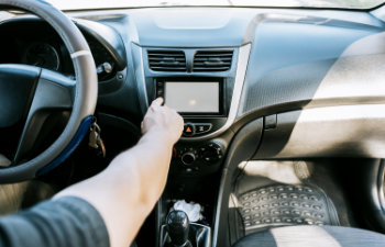 close up of driver tuning into the radio station