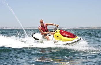 young men cruising on the atlantic ocean on a jet ski